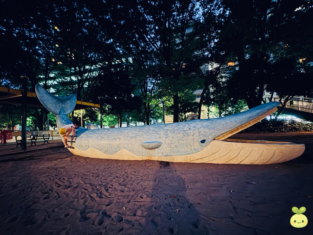 Whale-shaped playground slide at Shinjuku Central Park, a popular play area for kids
